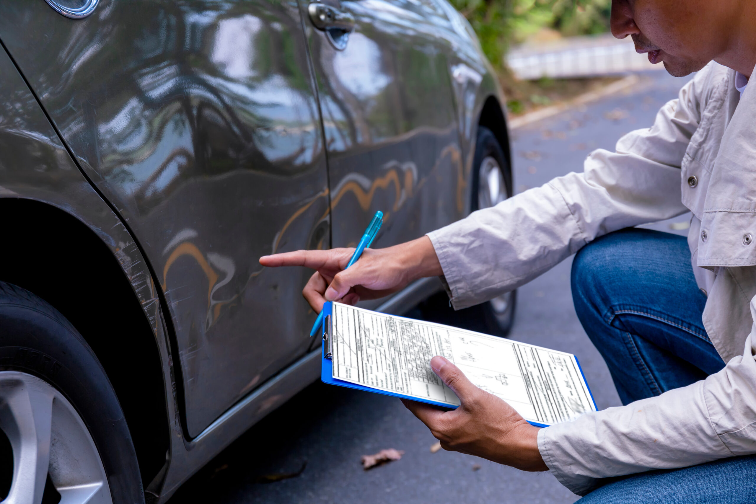 insurance adjuster inspecting vehicle after a car accident