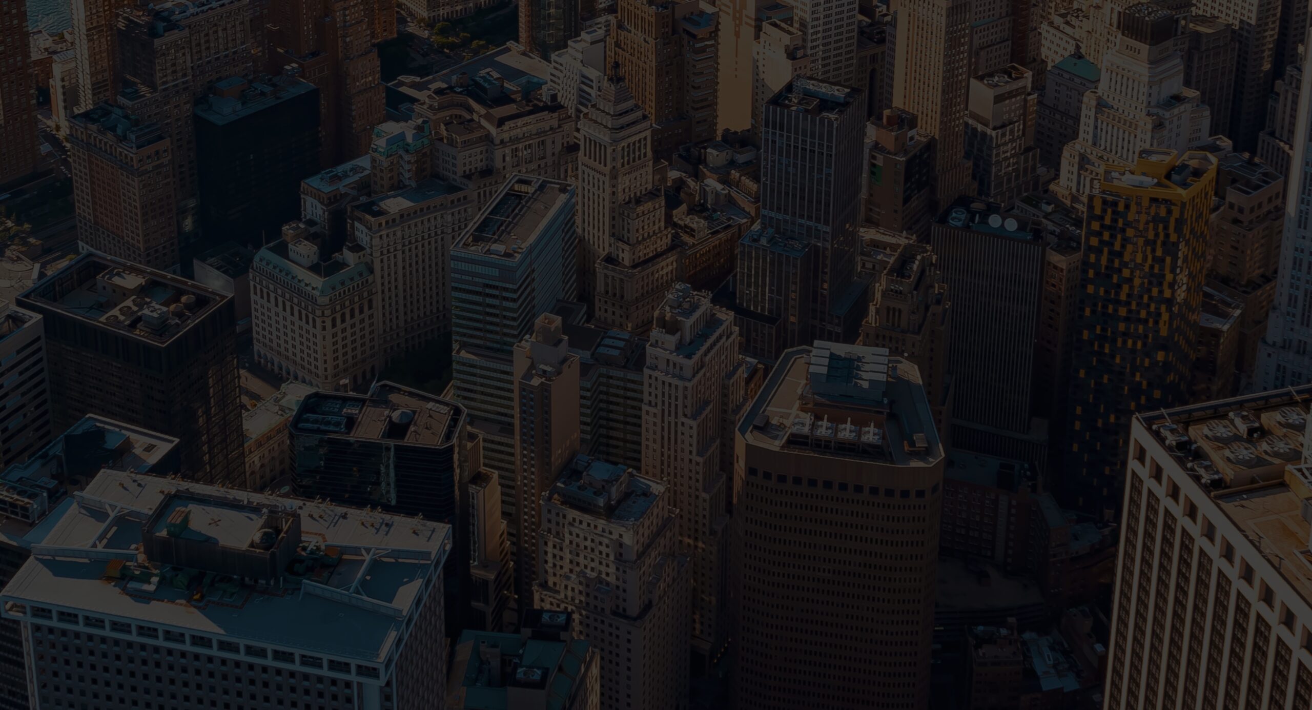 Aerial view of a densely packed cityscape with numerous tall buildings. The structures are a mix of modern and older architectural styles, creating a diverse urban skyline. Notably, the bustling streets below feature various offices, including personal injury attorneys ready to assist those in need.