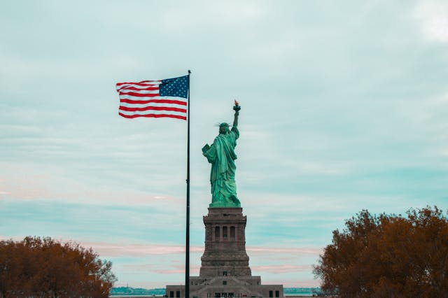 statue of liberty and American flag